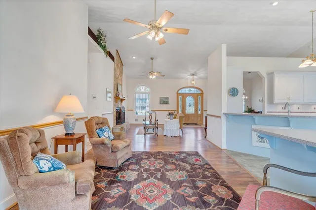 a living room with kitchen island furniture and a chandelier