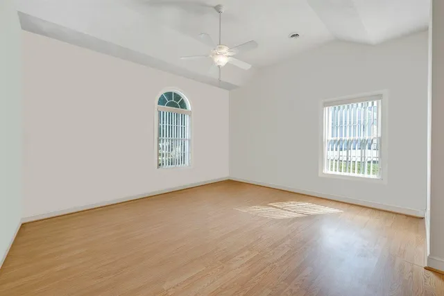 a front view of house with yard and trees in the background
