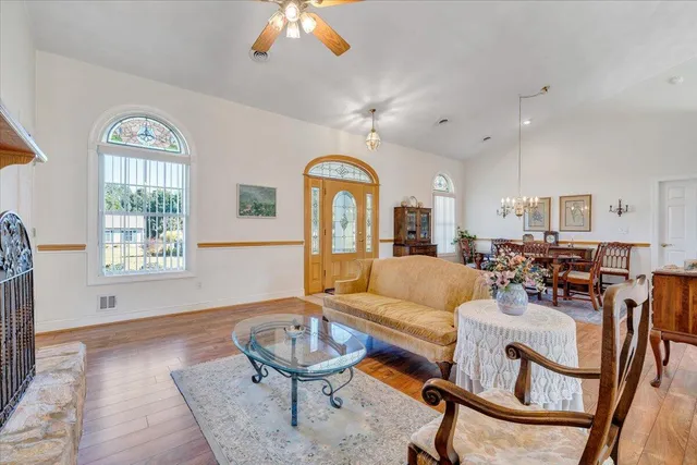 a living room with fireplace furniture and a chandelier