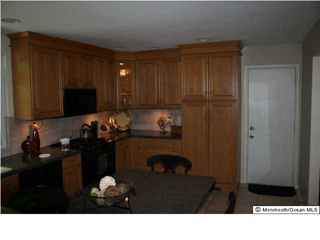 60 Newbury Road Howell, NJ 07731 - Photo 2 of 3 a kitchen with a sink cabinets and appliances