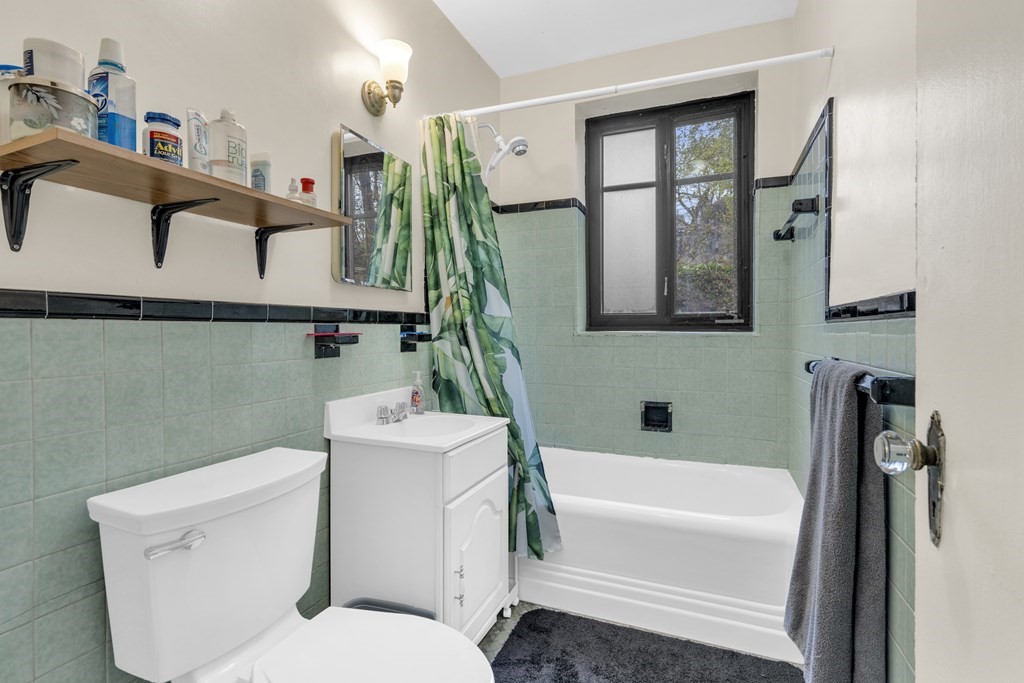 65 Strathmore Road, Unit 21 Boston, MA 02135 - Photo 4 of 10 a bathroom with a toilet a sink and bathtub