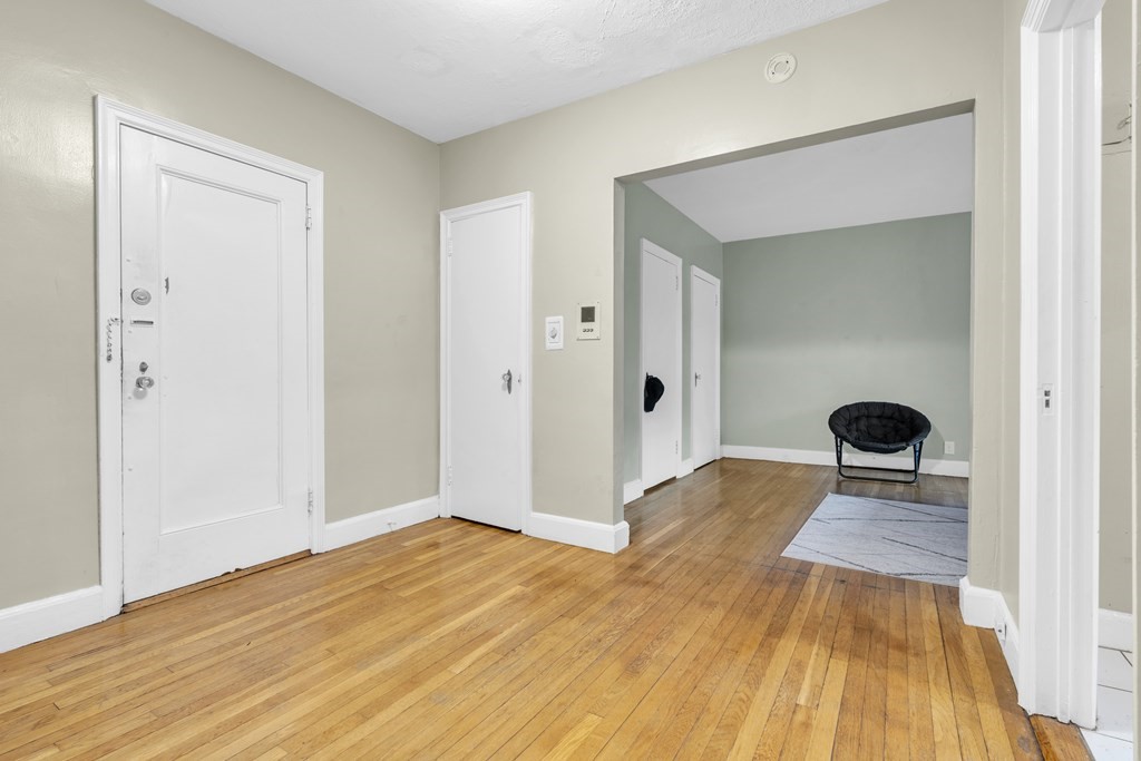 65 Strathmore Road, Unit 21 Boston, MA 02135 - Photo 5 of 10 wooden floor in a hall with an entryway