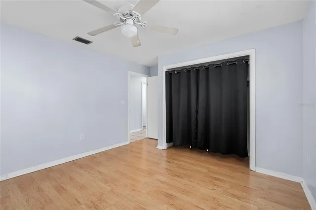 a view of an empty room with a fan