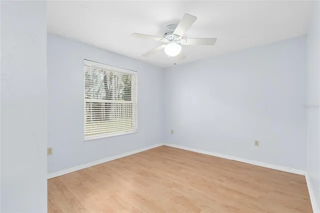 a view of a room with a ceiling fan and a window