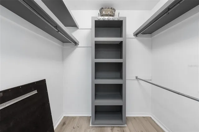 a view of walk in closet with empty racks