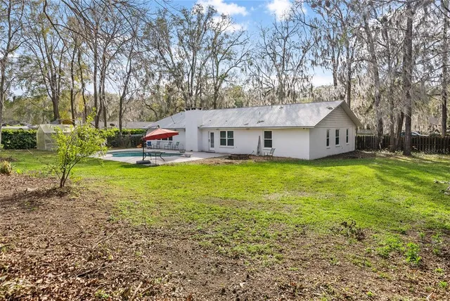 a view of a house with a yard and sitting area