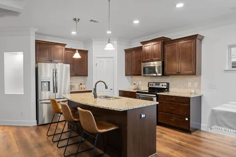 a front view of a house with a garden