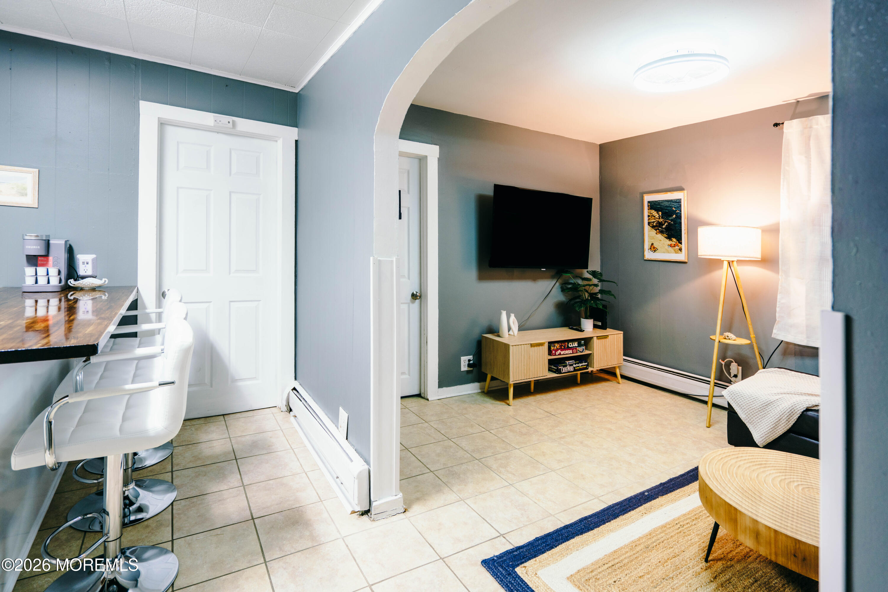 a bedroom with furniture and a flat screen tv