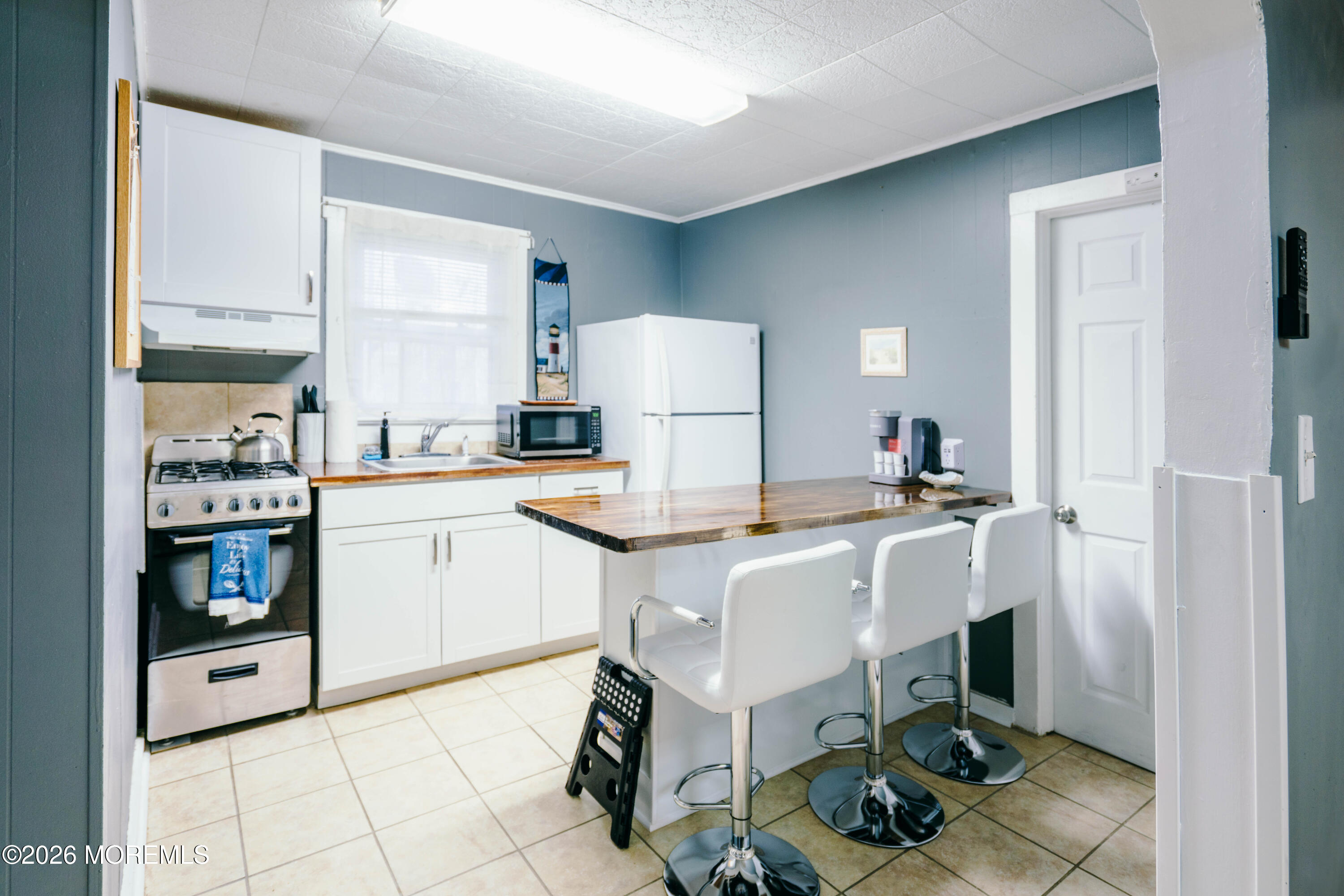 13 Decatur Avenue, Unit C Seaside Park, NJ 08752 - Photo 4 of 35 a kitchen with a sink cabinets and window