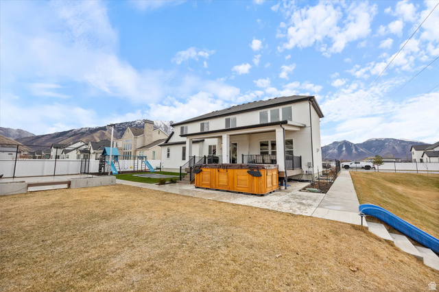 754 West 400 North, Unit 29 Mapleton, UT 84664 - Photo 25 of 25 Rear view of house with a playground, a fenced backyard, stucco siding, and a deck with mountain view