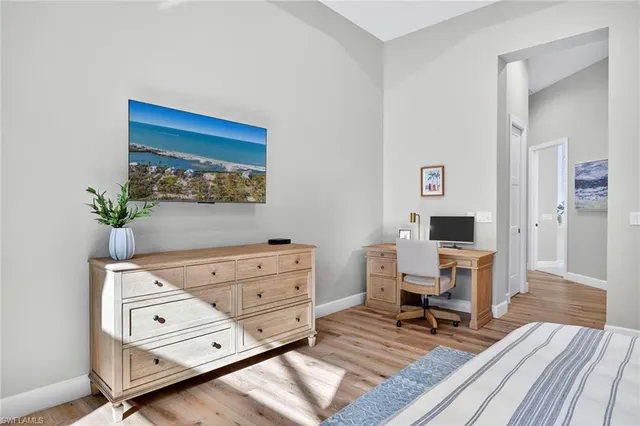 a living room with furniture and a dresser