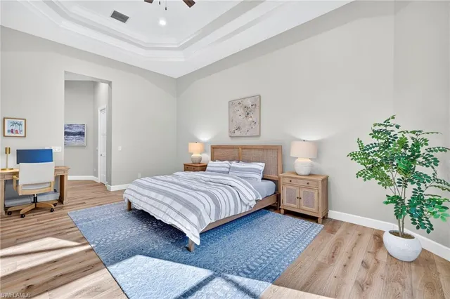 a bedroom with a bed and a potted plant