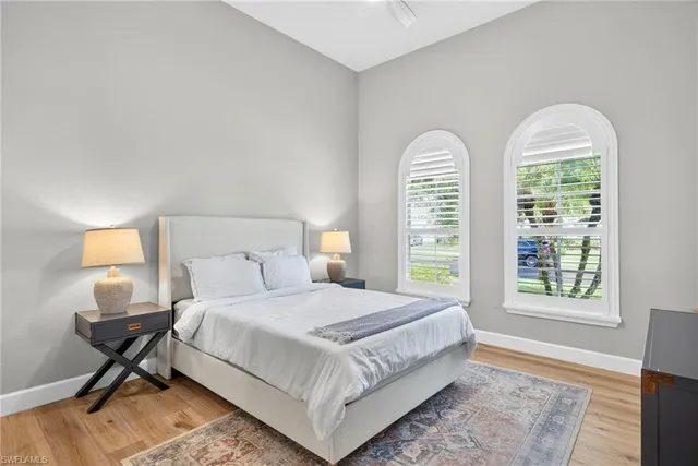 a bedroom with a bed a window and a lamp