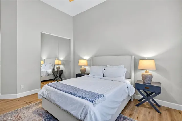 a bedroom with a bed a lamps and a table