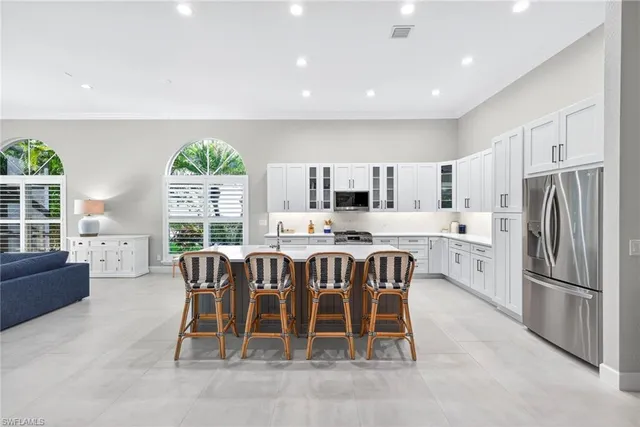 a large kitchen with a table and chairs in it