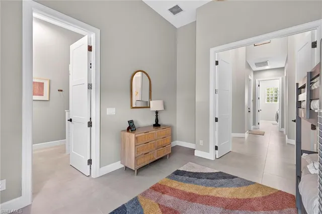a spacious bedroom with a bed and a cabinets