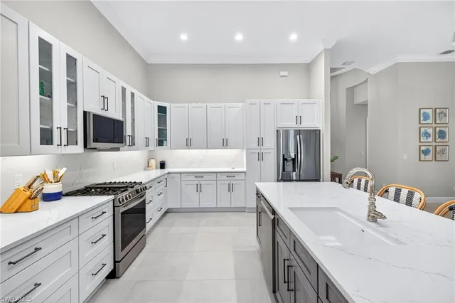 a kitchen with a sink stove top oven and refrigerator
