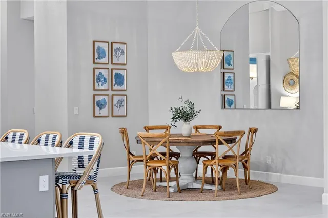 a view of a dining room with furniture and a chandelier