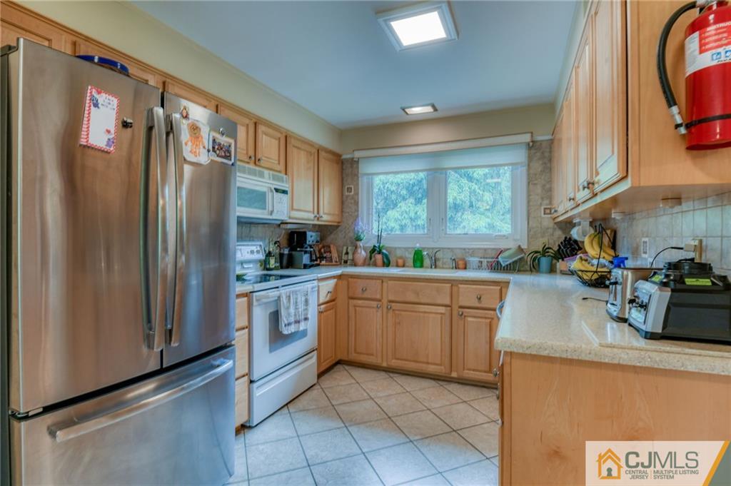 3 Spruce Lane Princeton, NJ 08540 - Photo 9 of 34 a kitchen with stainless steel appliances granite countertop a refrigerator and a sink