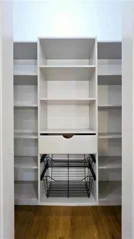 a bathroom with a white tub shower and sink
