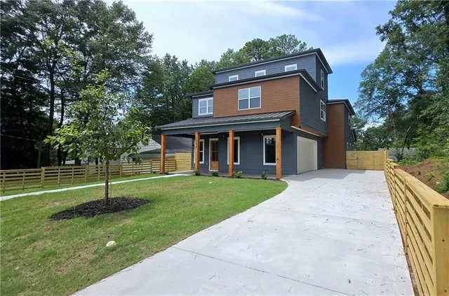 a view of a porch with a floor to ceiling window and front door