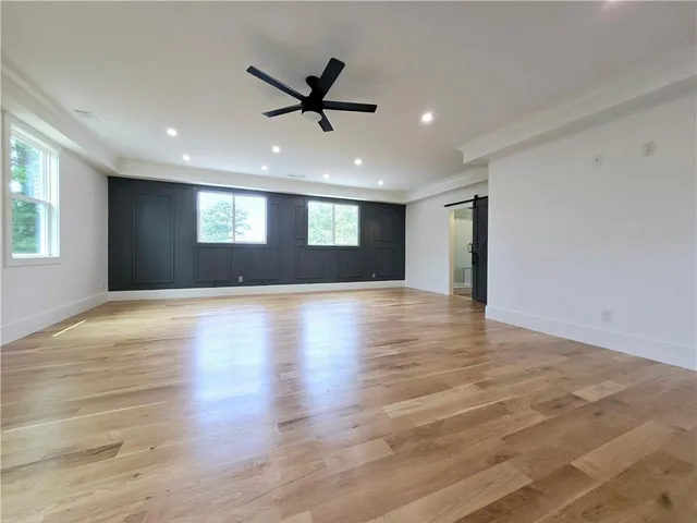 a bathroom with a shower sink mirror and toilet