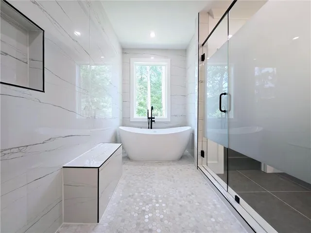 an empty room with a window and a ceiling fan