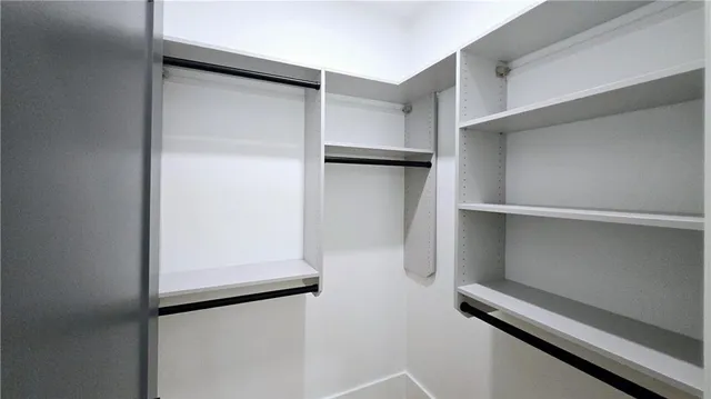 a living room with furniture kitchen view and a large window