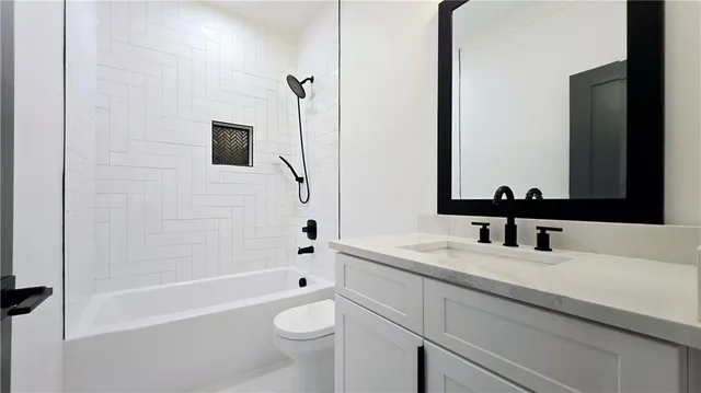 a living room with stainless steel appliances furniture and a flat screen tv