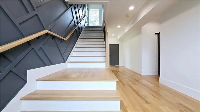 a living room with stainless steel appliances furniture and a flat screen tv