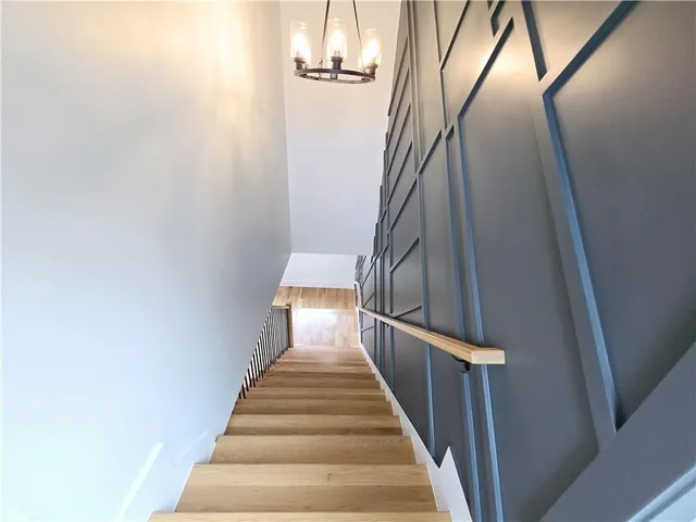 a bedroom with a bed lamp and a potted plant