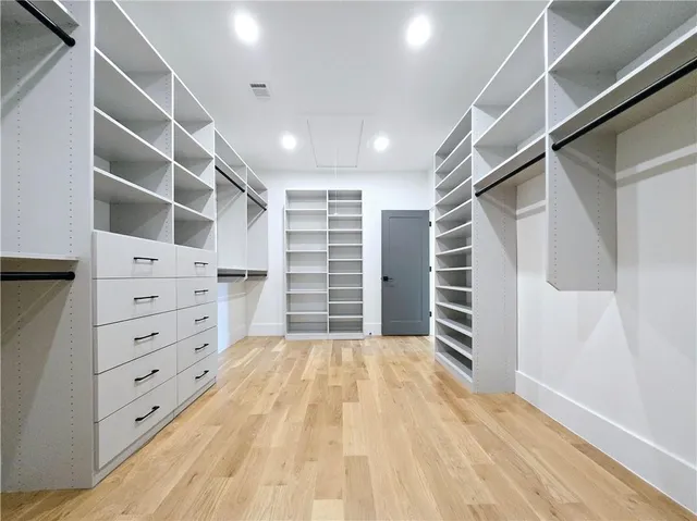 a spacious bedroom with a large bed and a couch