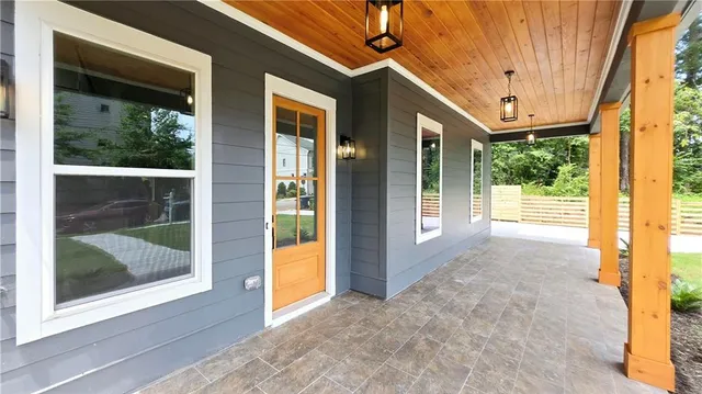 a large kitchen with stainless steel appliances kitchen island granite countertop a large counter top and a stove top oven