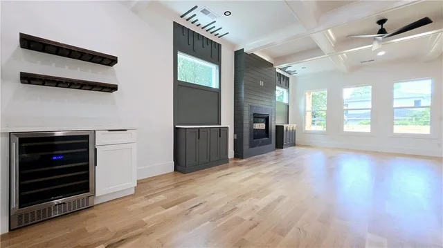 a kitchen with stainless steel appliances lots of counter top space and wooden floor