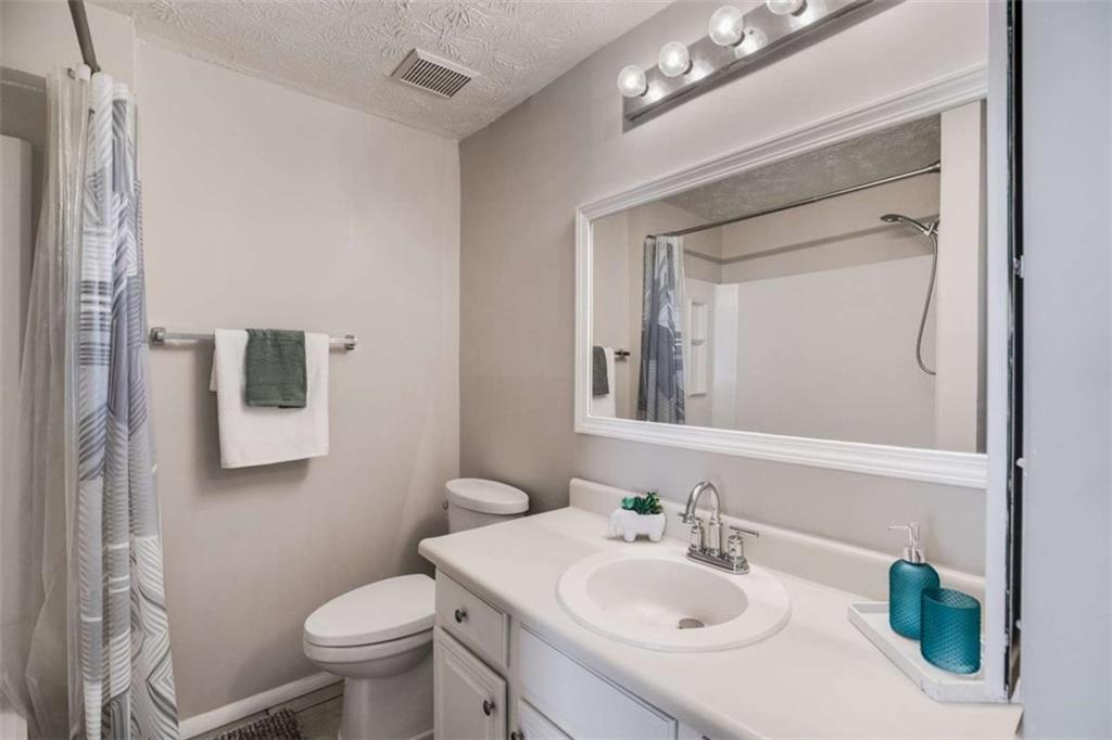 6413 Wedgewood Trace Tucker, GA 30084 - Photo 14 of 30 a bathroom with a sink a toilet and mirror