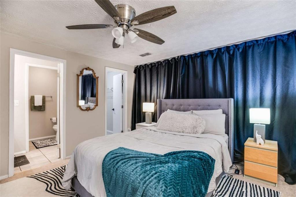 6413 Wedgewood Trace Tucker, GA 30084 - Photo 15 of 30 a bedroom with a bed and wooden floor