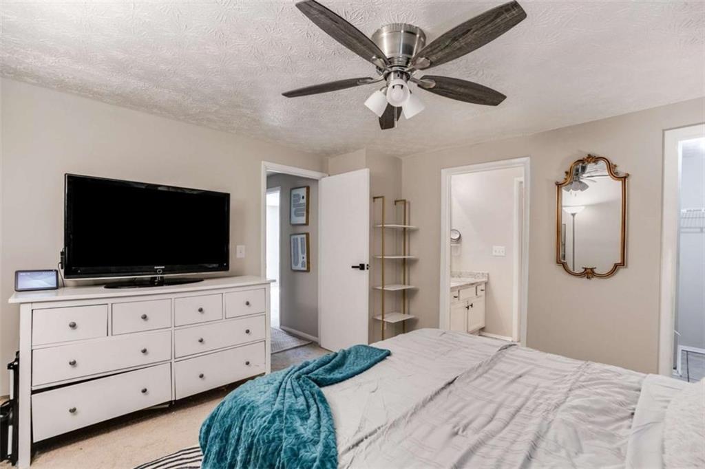 6413 Wedgewood Trace Tucker, GA 30084 - Photo 16 of 30 a bedroom with a bed and a flat screen tv in it