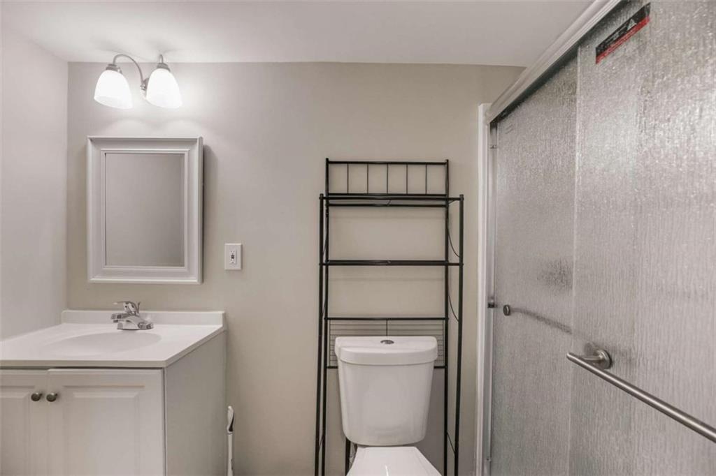 6413 Wedgewood Trace Tucker, GA 30084 - Photo 18 of 30 a bathroom with a toilet sink vanity and mirror