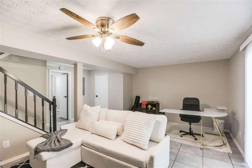 6413 Wedgewood Trace Tucker, GA 30084 - Photo 22 of 30 a living room with furniture and a chandelier
