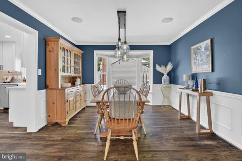 a view of a dining room with furniture and chandelier