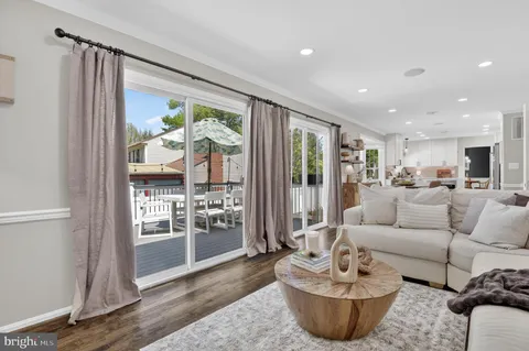 a living room with furniture and view of kitchen