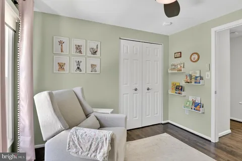 a living room with furniture gym equipment and a view of kitchen