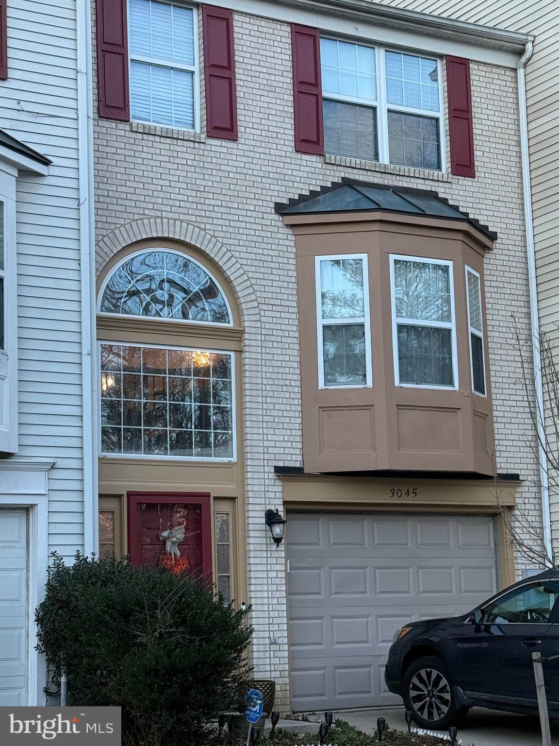 a front view of a building with a garden