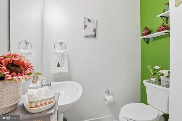 a bathroom with a toilet a sink and a mirror