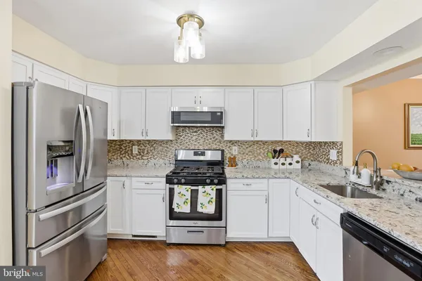 a kitchen with a refrigerator stove and sink