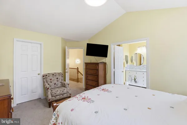 a bedroom with a bed and a television