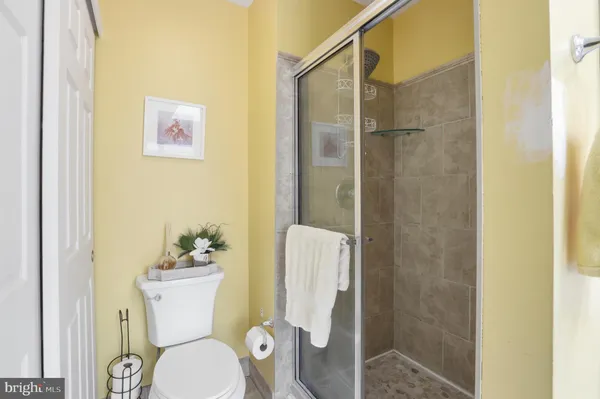 a white toilet sitting next to a bathroom sink