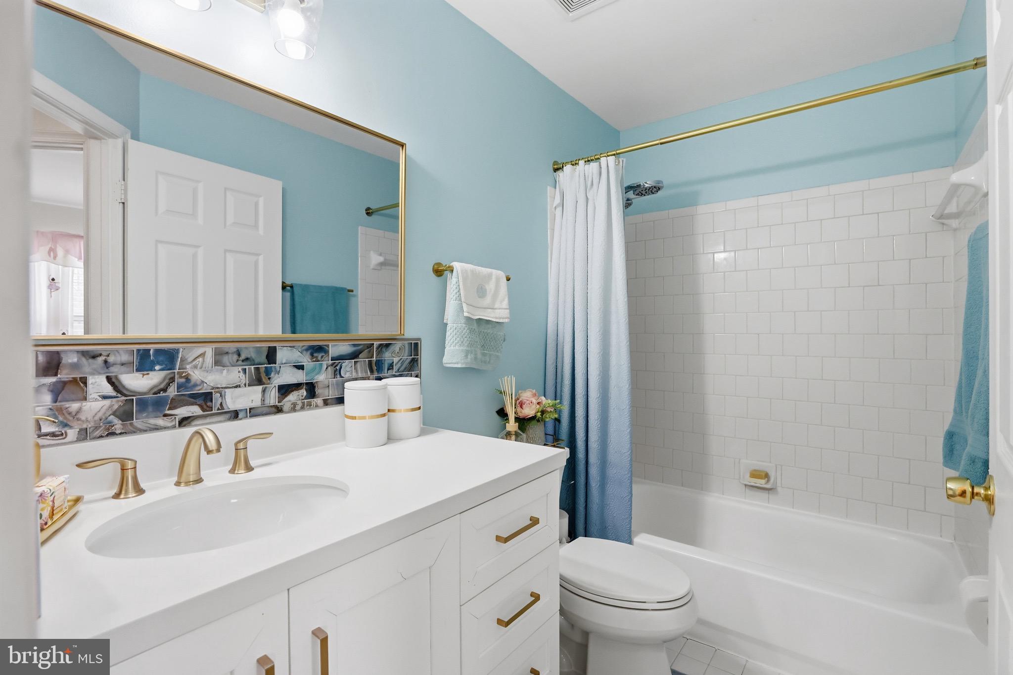 3045 Button Bush Lane Laurel, MD 20724 - Photo 23 of 28 a bathroom with a sink a toilet and a large mirror