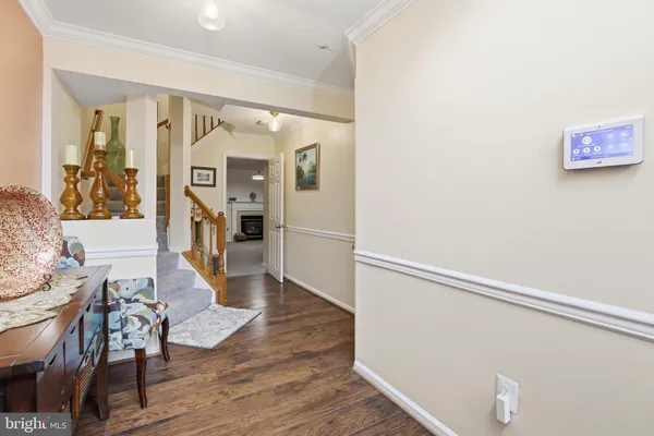 a view of a hallway with wooden floor and furniture
