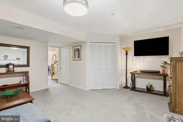 a view of a livingroom with entryway and a flat screen tv